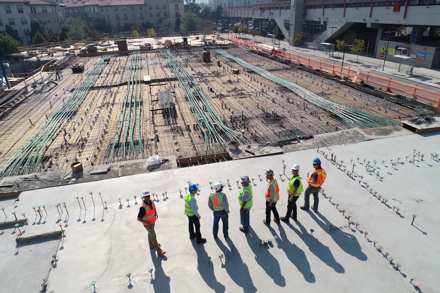 Aerial view of construction site with workers in safety vests