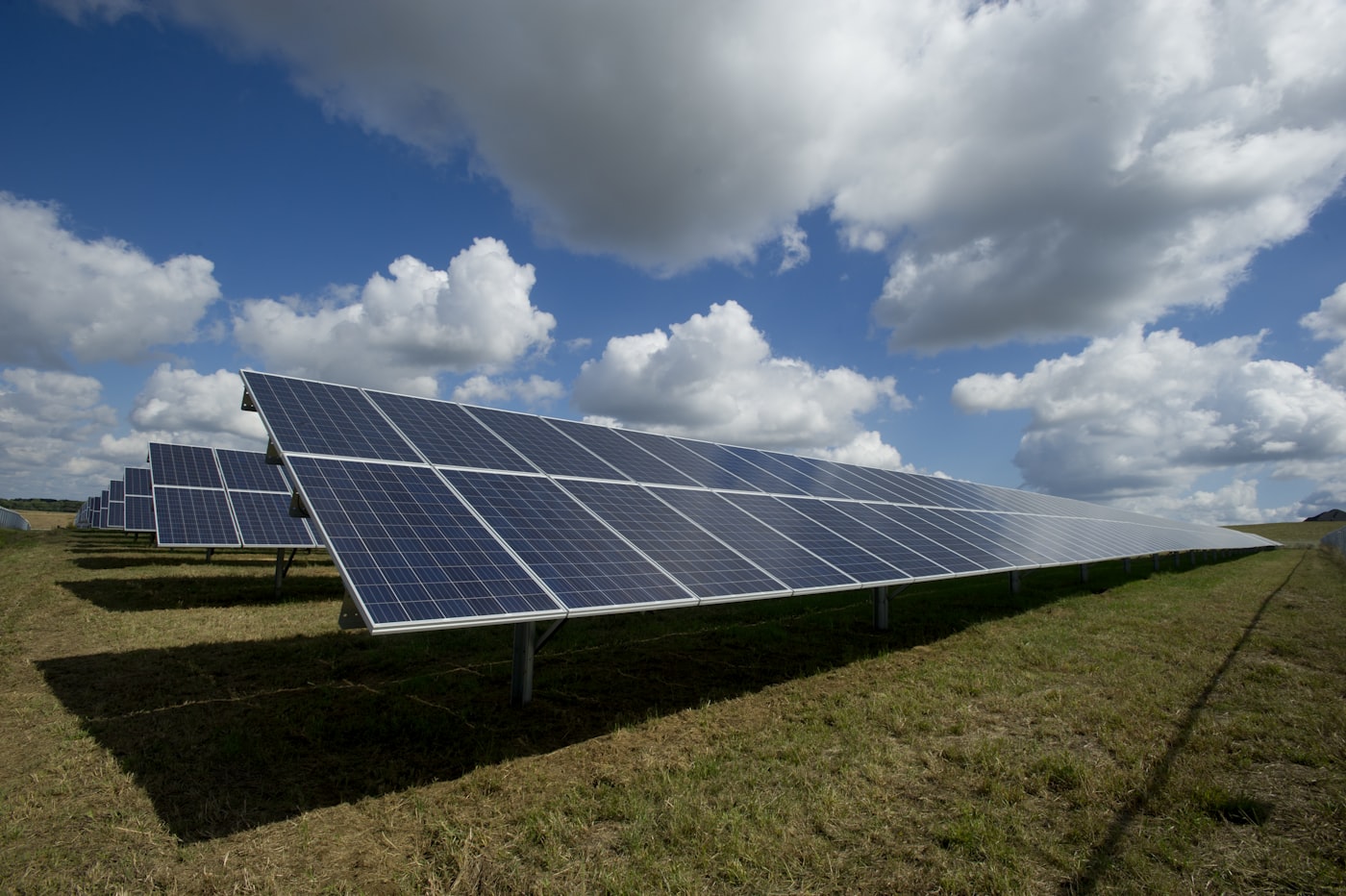 Commercial solar panel farm under blue sky